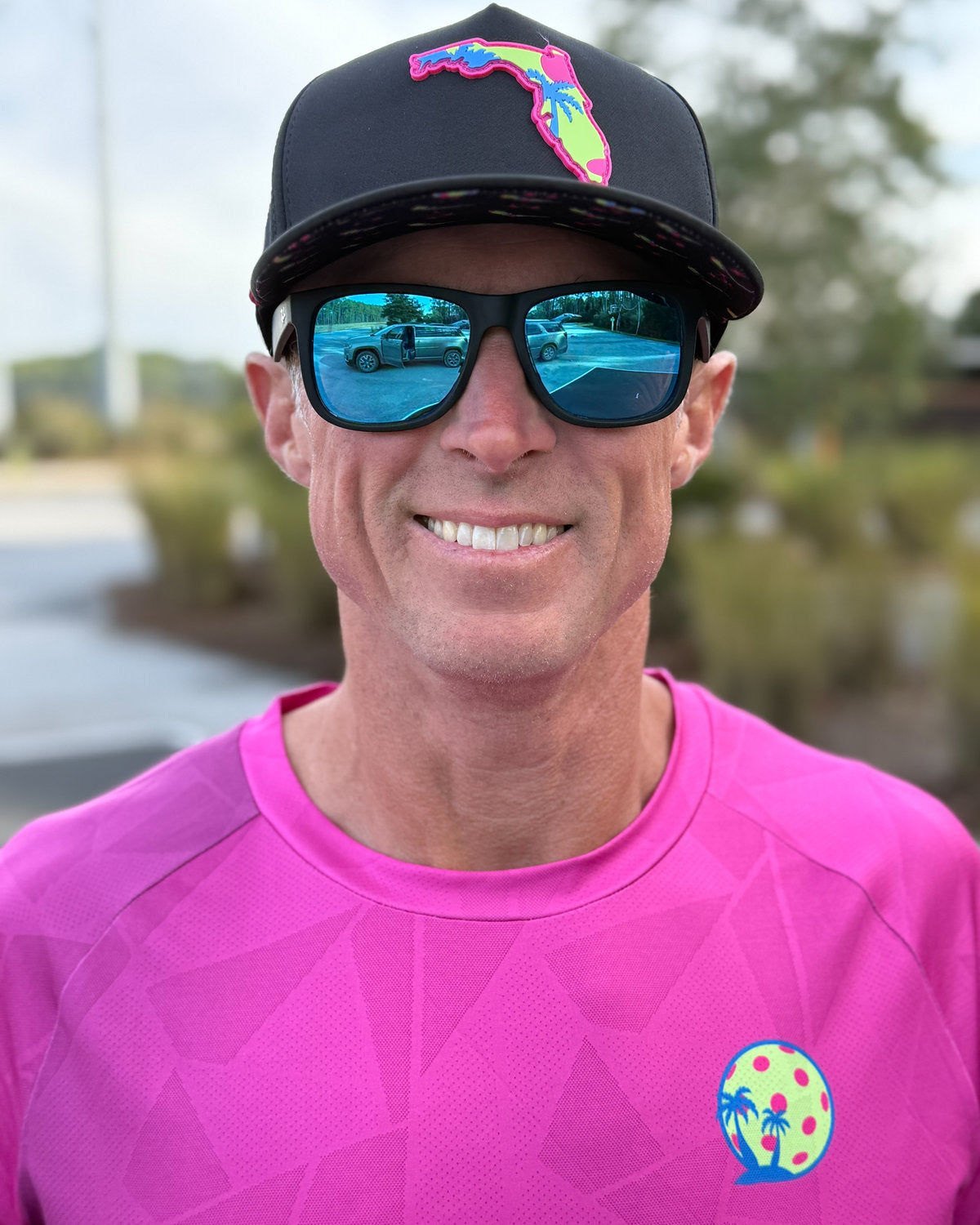Pickleball player wearing Sunsets and Dinks gear